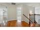 Bright hallway with hardwood flooring featuring stairway and views into other rooms at 4133 Hoffmeister Dr, Waxhaw, NC 28173