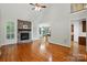 Cozy living room with a stone fireplace, hardwood floors, and ample natural light at 4133 Hoffmeister Dr, Waxhaw, NC 28173