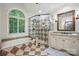 Bright bathroom with granite countertops, soaking tub, glass shower, and tile flooring at 4133 Hoffmeister Dr, Waxhaw, NC 28173