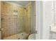 A tiled shower featuring decorative tile designs, a shower bench, and a glass surround at 4133 Hoffmeister Dr, Waxhaw, NC 28173