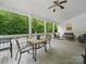 Spacious back porch features a ceiling fan and furniture, perfect for enjoying the outdoors at 419 Wade St, Wadesboro, NC 28170