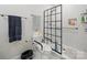 Bathroom featuring a walk-in shower with handicap bars, tile floor, and toilet with handicap bars at 419 Wade St, Wadesboro, NC 28170