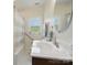Bright bathroom featuring modern vanity, round mirror, patterned shower curtain and a window at 419 Wade St, Wadesboro, NC 28170