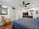 Well-lit bedroom with wood floors, a ceiling fan, and a cozy chair at 419 Wade St, Wadesboro, NC 28170
