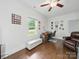 Bright bedroom with hardwood floors, a seating area, and a desk for workspace at 419 Wade St, Wadesboro, NC 28170