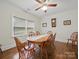 Dining room with a wooden table and chairs, hardwood floors, and a ceiling fan at 419 Wade St, Wadesboro, NC 28170