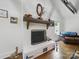 Close up of a white brick fireplace with wood mantle, hardwood floors and comfortable seating at 419 Wade St, Wadesboro, NC 28170
