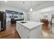 Bright, open kitchen featuring an island, stainless steel sink, and hardwood floors, open to dining and living areas at 419 Wade St, Wadesboro, NC 28170