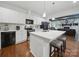 Bright kitchen features white cabinets, stainless steel appliances, and a center island at 419 Wade St, Wadesboro, NC 28170