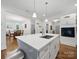 Bright kitchen boasts an island with white countertops, stainless steel accents, and hardwood floors at 419 Wade St, Wadesboro, NC 28170