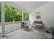 Outdoor porch with neutral toned furniture, white railing, and a lovely view of the trees at 419 Wade St, Wadesboro, NC 28170