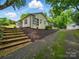 White brick exterior with black trim, stairs, and driveway at 419 Wade St, Wadesboro, NC 28170
