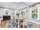 Bright dining room with a large table, seating for six, and a view of the backyard at 4236 Carrington Sw Ct, Concord, NC 28027