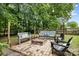 Backyard fire pit area with string lights and comfortable seating, ideal for outdoor entertaining at 4236 Carrington Sw Ct, Concord, NC 28027