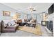Comfortable living room with a large sectional sofa, ceiling fan, and stylish decor at 4236 Carrington Sw Ct, Concord, NC 28027