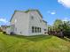 Spacious backyard features a well-maintained lawn, a wooden deck, and a two-story home at 4576 Fox Ridge Ln, Fort Mill, SC 29707