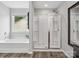 Bathroom features a soaking tub, a separate glass-enclosed shower, and a window at 4576 Fox Ridge Ln, Fort Mill, SC 29707