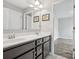 Bathroom features a double sink vanity with dark cabinetry, a large mirror, and neutral-colored walls at 4576 Fox Ridge Ln, Fort Mill, SC 29707