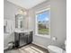 Bathroom featuring wood-look floors, a vanity with sink, and a window with neighborhood views at 4576 Fox Ridge Ln, Fort Mill, SC 29707