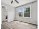 Bright bedroom featuring wood-look floors, a ceiling fan and natural light from large windows at 4576 Fox Ridge Ln, Fort Mill, SC 29707