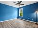 Bedroom boasts bright blue walls, a ceiling fan, a window and wood-look flooring at 4576 Fox Ridge Ln, Fort Mill, SC 29707