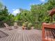 A wooden deck furnished with chairs, planters, and surrounded by trees provides a relaxing outdoor space at 4576 Fox Ridge Ln, Fort Mill, SC 29707