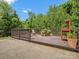 A wooden deck with chairs and planters offers serene views and outdoor enjoyment at 4576 Fox Ridge Ln, Fort Mill, SC 29707