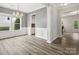 Elegant dining room with wainscoting detail, grey walls, a modern light fixture and hardwood floors at 4576 Fox Ridge Ln, Fort Mill, SC 29707
