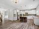 Open concept kitchen featuring a central island with seating and stainless steel appliances with modern flooring at 4576 Fox Ridge Ln, Fort Mill, SC 29707