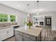 Kitchen island with granite countertops and adjacent Gathering room, creating an inviting gathering space at 4576 Fox Ridge Ln, Fort Mill, SC 29707