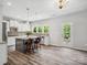 Spacious kitchen with white cabinets, grey island, hardwood floors and stainless steel appliances at 4576 Fox Ridge Ln, Fort Mill, SC 29707