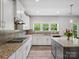 Bright kitchen featuring granite countertops, a gas range, and ample cabinet space with modern flooring at 4576 Fox Ridge Ln, Fort Mill, SC 29707