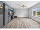 Spacious living room featuring wood-look floors, a custom built-in unit, and natural light from windows at 4576 Fox Ridge Ln, Fort Mill, SC 29707