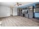 Spacious living room featuring wood-look floors, a custom built-in unit, and natural light from windows at 4576 Fox Ridge Ln, Fort Mill, SC 29707