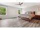 Bright main bedroom featuring hardwood floors, two windows, and natural light at 4576 Fox Ridge Ln, Fort Mill, SC 29707
