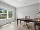 Bright office space featuring hardwood floors, neutral walls, and a large window overlooking the yard at 4576 Fox Ridge Ln, Fort Mill, SC 29707