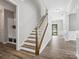 Staircase leading to the second floor with hardwood steps, white risers and neutral walls at 4576 Fox Ridge Ln, Fort Mill, SC 29707