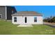 Backyard featuring a small concrete patio, level grassy area, and vinyl siding at 4677 Fanning Rd, Hickory, NC 28602