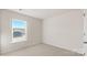 Bright bedroom with plush carpeting and a window overlooking neighborhood homes at 4677 Fanning Rd, Hickory, NC 28602