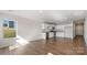 Open-concept kitchen features white cabinets, stainless steel appliances, and hardwood floors at 4677 Fanning Rd, Hickory, NC 28602