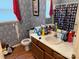 Cozy bathroom features floral wallpaper, a shower with curtain, and a single sink vanity at 508 Hillcrest St, Marshville, NC 28103