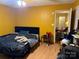 Bedroom features yellow walls, an adjustable bed with blue headboard, and a small side table at 508 Hillcrest St, Marshville, NC 28103