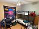 Bedroom featuring a bunk bed, gaming chair, and laminate flooring at 508 Hillcrest St, Marshville, NC 28103