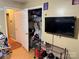 Bedroom featuring a closet with hanging clothes, a television, and laminate flooring at 508 Hillcrest St, Marshville, NC 28103