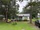 Quaint one-story home featuring a well-manicured lawn, mature trees, and charming curb appeal at 508 Hillcrest St, Marshville, NC 28103