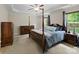 Main bedroom with a four-poster bed, tray ceilings, and natural light from windows at 5369 Concord Rd, York, SC 29745