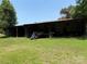 Open-air barn with equipment and storage, on a grassy lot at 6018 Unionville Rd, Monroe, NC 28110