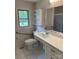Accessible bathroom with a modern vanity, open shelving, and tiled floor at 6018 Unionville Rd, Monroe, NC 28110