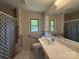 Accessible bathroom with a modern vanity and tile backsplash and grab bars at 6018 Unionville Rd, Monroe, NC 28110