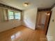 Bedroom with hardwood floors, decorative wallpaper border, and natural light at 6018 Unionville Rd, Monroe, NC 28110